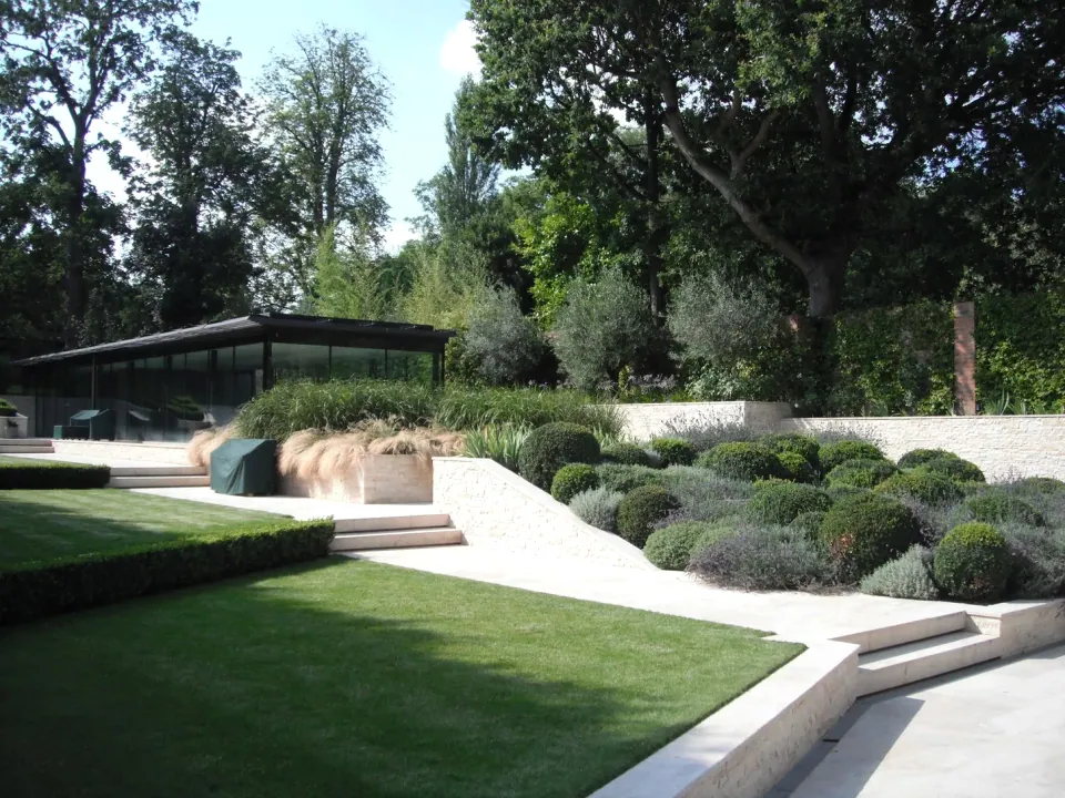 Landscaped lawn, clipped shrubs and stone steps from the Green Fingers Gardens archive